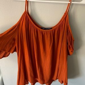 Burnt orange tank/shirt. Shoulder area exposed. Size medium.